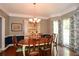 Cozy dining room with a classic chandelier, wood table, and natural light, perfect for Gathering meals at 49 Timberlake Ne Cv, Cartersville, GA 30121