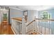 Bright hallway features wood flooring, staircase with white railings, and a large window offering natural light at 49 Timberlake Ne Cv, Cartersville, GA 30121