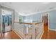 Open hallway boasts hardwood floors, a modern light fixture, and views into adjacent rooms and a window at 49 Timberlake Ne Cv, Cartersville, GA 30121