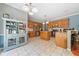 Bright kitchen features stainless appliances, tile floors, wood cabinets, kitchen island, and unique turquoise hutch at 49 Timberlake Ne Cv, Cartersville, GA 30121