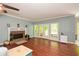 Open-concept living room with hardwood floors, a brick fireplace, and french doors to the outdoor deck at 49 Timberlake Ne Cv, Cartersville, GA 30121