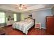 Tranquil main bedroom with a tray ceiling, hardwood floors, and neutral tones creating a peaceful retreat at 49 Timberlake Ne Cv, Cartersville, GA 30121