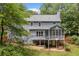 Back exterior of the house with a deck, screened porch, and patio, showcasing outdoor living at 49 Timberlake Ne Cv, Cartersville, GA 30121