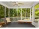 Relaxing screened porch with comfortable seating, a ceiling fan, and serene wooded views at 49 Timberlake Ne Cv, Cartersville, GA 30121