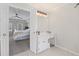 En suite vanity and mirror with a view to the primary bedroom and connecting bath at 530 Veranda Ct, Alpharetta, GA 30009