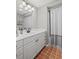 Bathroom featuring a vanity, medicine cabinet, and a shower with gray tiling at 530 Veranda Ct, Alpharetta, GA 30009