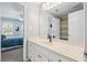 Bright bathroom featuring a vanity with white countertop, framed mirror, and access to bedroom at 530 Veranda Ct, Alpharetta, GA 30009