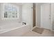 Bathroom featuring a luxurious soaking tub and a separate glass-enclosed shower at 530 Veranda Ct, Alpharetta, GA 30009