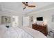 Primary bedroom with a tray ceiling, large bed and a view into the en suite bath at 530 Veranda Ct, Alpharetta, GA 30009