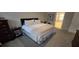Comfortable bedroom with plush carpet, a large bed, and neutral decor at 530 Veranda Ct, Alpharetta, GA 30009