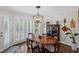 Bright dining room with shuttered windows and elegant lighting fixture at 530 Veranda Ct, Alpharetta, GA 30009
