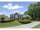 Charming brick home with a well-maintained lawn, driveway, and mature trees offering curb appeal at 530 Veranda Ct, Alpharetta, GA 30009