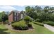 Landscaped lawn with mature shrubbery highlighting this 2-story brick home at 530 Veranda Ct, Alpharetta, GA 30009
