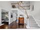 Bright foyer featuring hardwood floors, staircase, and stylish decor elements at 530 Veranda Ct, Alpharetta, GA 30009