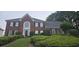 Charming brick home featuring a well-manicured lawn and welcoming front entrance at 530 Veranda Ct, Alpharetta, GA 30009