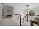 Bright hallway with decorative lighting fixture, wainscoting and trim, carpet, and arched windows at 530 Veranda Ct, Alpharetta, GA 30009