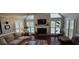Cozy living room with fireplace, plantation shutters, and ample natural light at 530 Veranda Ct, Alpharetta, GA 30009
