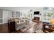Bright living room features hardwood floors, fireplace, and ample windows, creating a cozy and inviting atmosphere at 530 Veranda Ct, Alpharetta, GA 30009