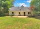 Spacious backyard featuring a patio and lush green lawn, perfect for outdoor entertaining at 575 Freeman Dr, Covington, GA 30016