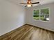 Cozy bedroom with hardwood floors, ceiling fan, and a bright window view at 575 Freeman Dr, Covington, GA 30016