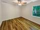 Bright bedroom with hardwood floors, a ceiling fan, and large window views at 575 Freeman Dr, Covington, GA 30016
