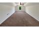 Expansive bonus room with high ceilings, ceiling fan, and plush carpeting at 575 Freeman Dr, Covington, GA 30016