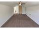 Large bonus room with a ceiling fan, neutral carpet, and a glimpse into the bathroom at 575 Freeman Dr, Covington, GA 30016