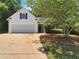 Charming one-story home featuring a well-manicured lawn and attached two-car garage at 575 Freeman Dr, Covington, GA 30016