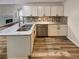 Modern kitchen featuring stainless appliances, granite counters, and white cabinetry at 575 Freeman Dr, Covington, GA 30016