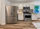 Modern kitchen featuring stainless steel appliances and granite countertops at 575 Freeman Dr, Covington, GA 30016