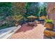 Brick patio with a grill and outdoor seating in landscaped backyard at 1255 Beech Haven Ne Rd, Atlanta, GA 30324