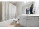 Bathroom featuring a shower-tub combo with shower curtain and a single sink vanity at 1255 Beech Haven Ne Rd, Atlanta, GA 30324