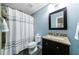 Bathroom featuring blue walls, tiled floor, granite vanity, toilet, and shower with curtain at 1255 Beech Haven Ne Rd, Atlanta, GA 30324