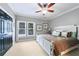 A spacious bedroom with a ceiling fan and a white wooden bed frame topped with decorative pillows at 1255 Beech Haven Ne Rd, Atlanta, GA 30324