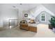 Upper-level bonus room with neutral decor, sloped ceilings, and a cozy sitting area at 1255 Beech Haven Ne Rd, Atlanta, GA 30324
