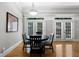 Dining room features hardwood floors, a modern chandelier, and multiple windows and doors at 1255 Beech Haven Ne Rd, Atlanta, GA 30324