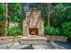 Outdoor fireplace area with stone surround and lush landscaping is great for entertaining at 1255 Beech Haven Ne Rd, Atlanta, GA 30324