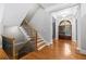 Bright foyer featuring hardwood floors, elegant columns, and staircase with wood and iron railings at 1255 Beech Haven Ne Rd, Atlanta, GA 30324