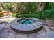 Beautiful raised hot tub with stone accents surrounded by lush landscaping and a tranquil setting at 1255 Beech Haven Ne Rd, Atlanta, GA 30324