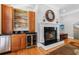 Living room featuring a wet bar with custom cabinetry, a wine fridge, and a fireplace at 1255 Beech Haven Ne Rd, Atlanta, GA 30324
