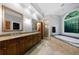 A luxurious bathroom featuring double sinks, granite counters, a soaking tub, and a glass enclosed shower at 1255 Beech Haven Ne Rd, Atlanta, GA 30324