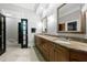 Bathroom with double sink vanity, decorative mirrors, and a glass enclosed shower, with access to bedroom at 1255 Beech Haven Ne Rd, Atlanta, GA 30324