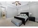 A bedroom featuring a tray ceiling, neutral walls, and a dark wood bed frame with an upholstered bench at 1255 Beech Haven Ne Rd, Atlanta, GA 30324