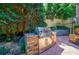 Built in stainless steel outdoor grill on brick patio with lush greenery in the background at 1255 Beech Haven Ne Rd, Atlanta, GA 30324
