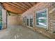 Covered brick patio featuring neutral tile, brick columns, and view of backyard at 1255 Beech Haven Ne Rd, Atlanta, GA 30324