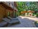 Relaxing outdoor patio area with lounge chairs, fireplace, and views of the lush backyard at 1255 Beech Haven Ne Rd, Atlanta, GA 30324