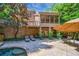 Spacious backyard patio with a screened in porch and pool surrounded by lush landscaping at 1255 Beech Haven Ne Rd, Atlanta, GA 30324