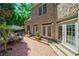 Brick patio with dining area and multiple entryways offers great flow to home's exterior at 1255 Beech Haven Ne Rd, Atlanta, GA 30324