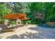Backyard pool area with lounge chairs, umbrellas, outdoor fireplace, and lush foliage at 1255 Beech Haven Ne Rd, Atlanta, GA 30324