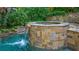 Outdoor pool featuring tile, calming waterfall feature, and lush landscaping at 1255 Beech Haven Ne Rd, Atlanta, GA 30324